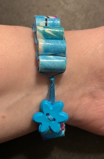 bottom of bracelet on wrist showing button closure