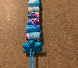 close-up of button strung on end of bracelet