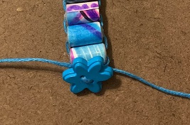 close-up of floss ends tied behind the button