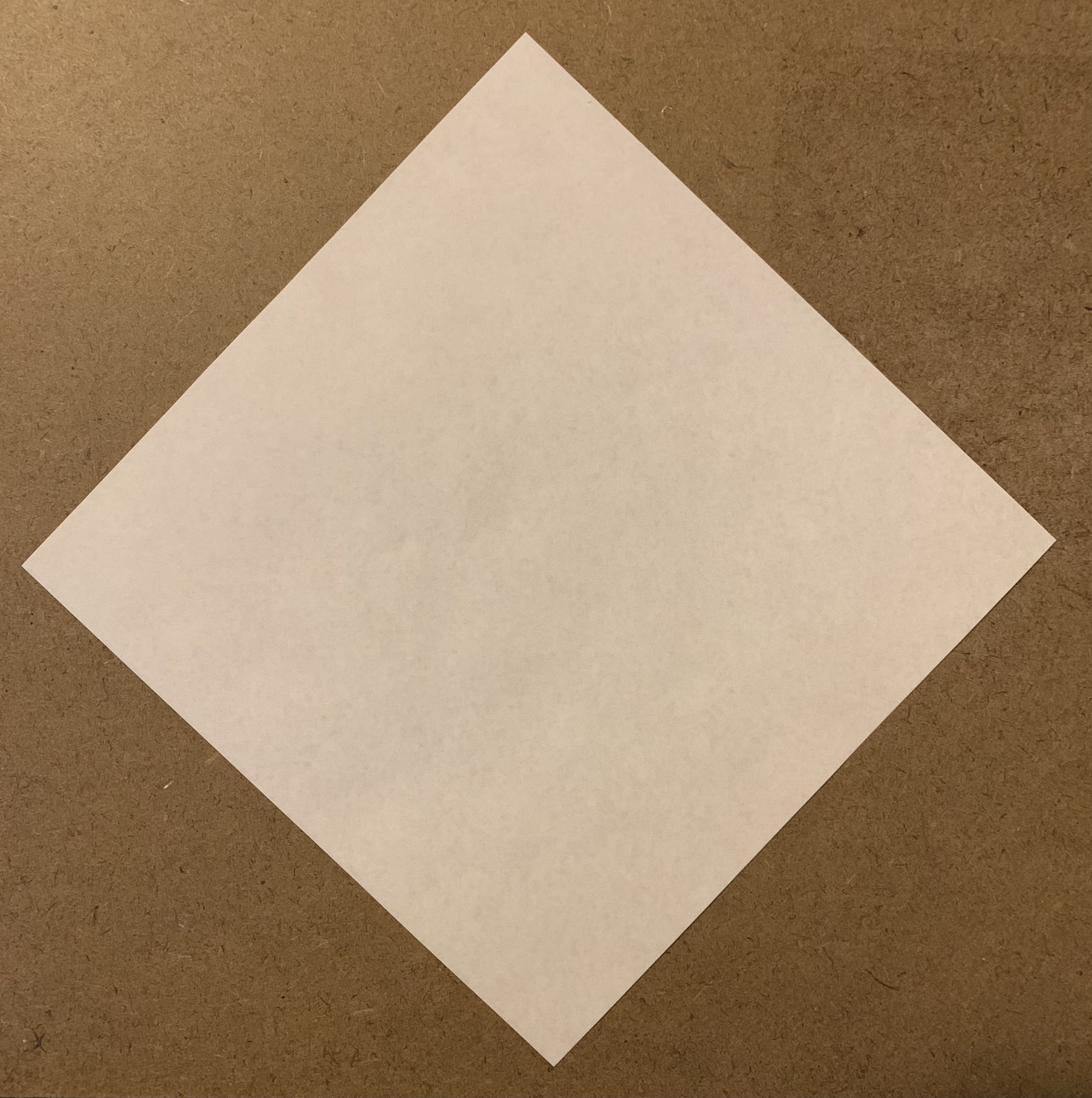 face-down origami paper in diamond orientation