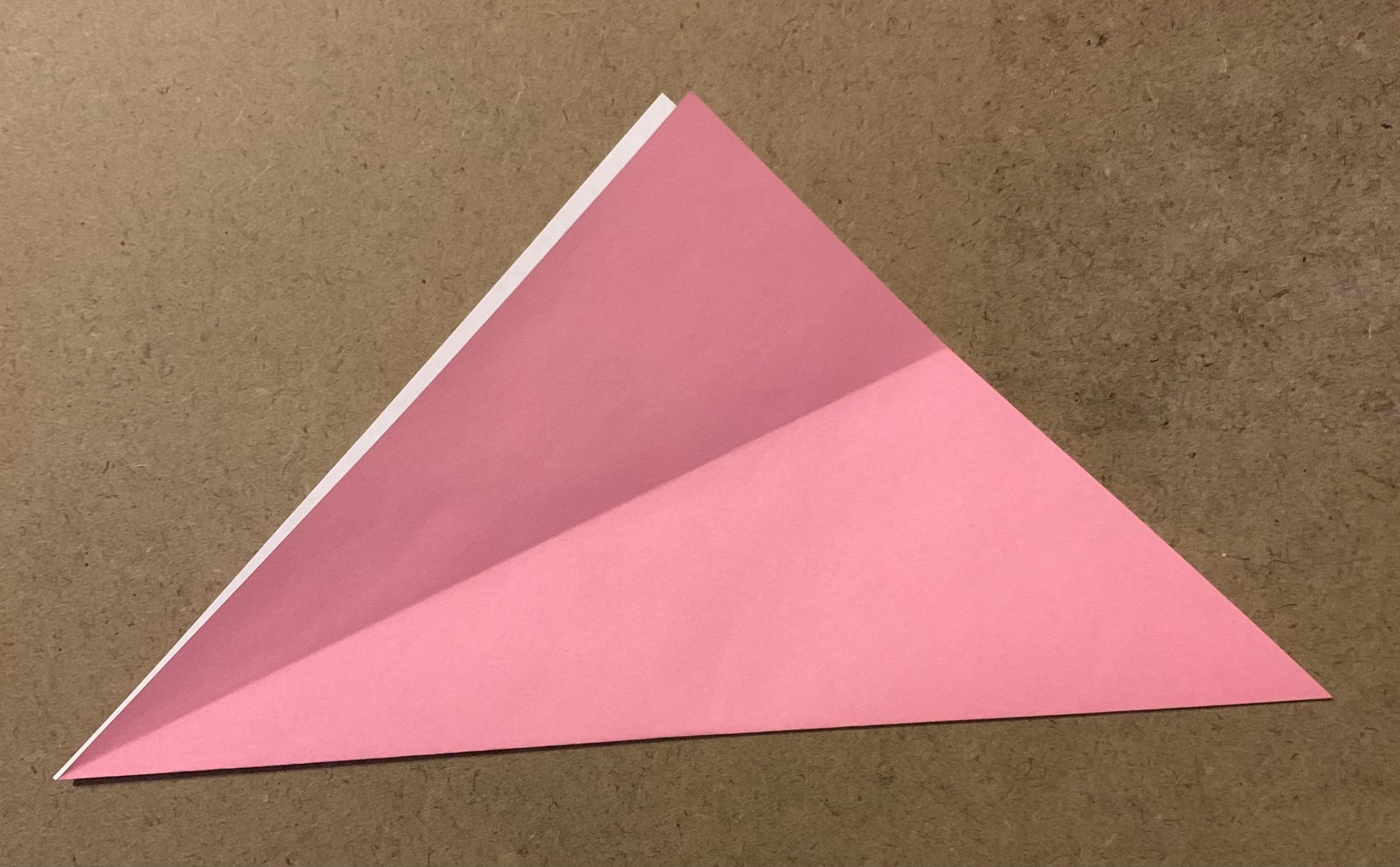 origami paper folded into triangle with crease along front flap