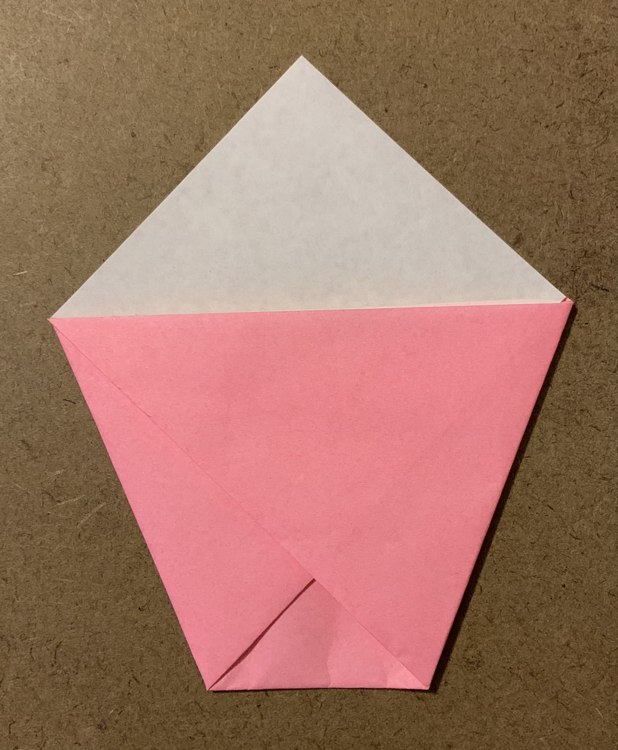 origami shape folded into cup with back top flap unfolded